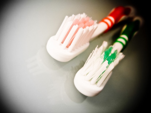 his and her tooth brushes.