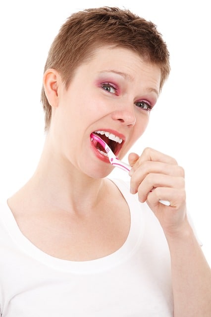 a woman brushing her teeth