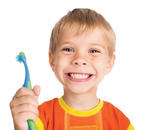 child smiling with toothbrush 