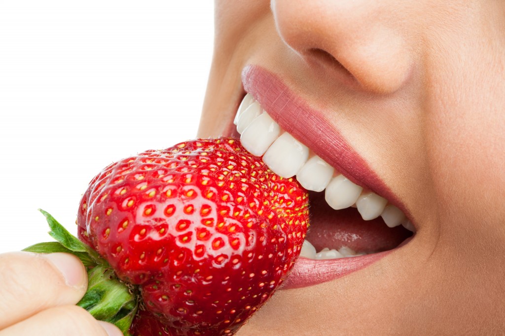 Woman eating strawberry