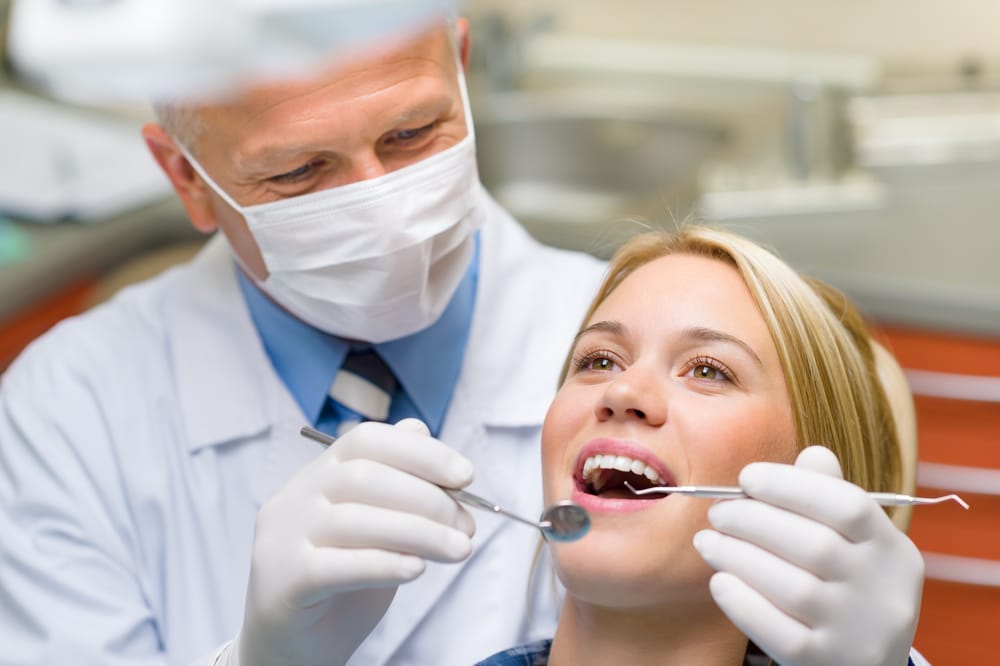 Dentist working on female patient