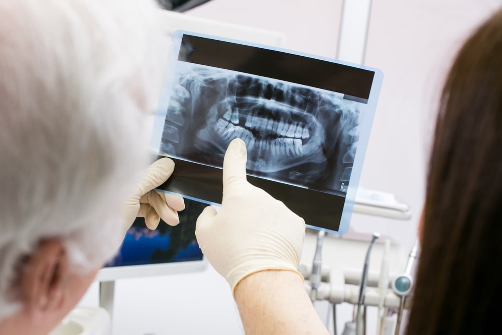 Dentist showing patient X-rays