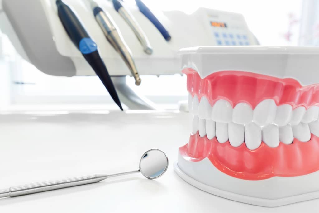 dentures next to dental equipment