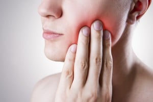 woman with a sore tooth because of an infection