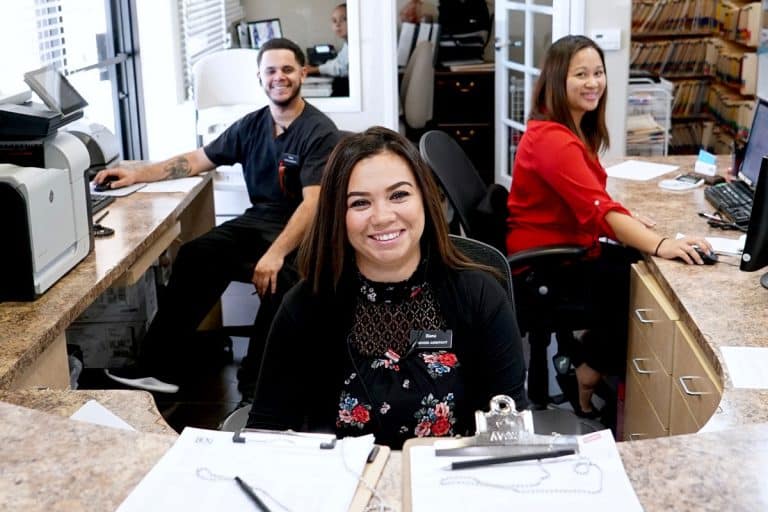 BDG reception office staff, smiling form behind their desk